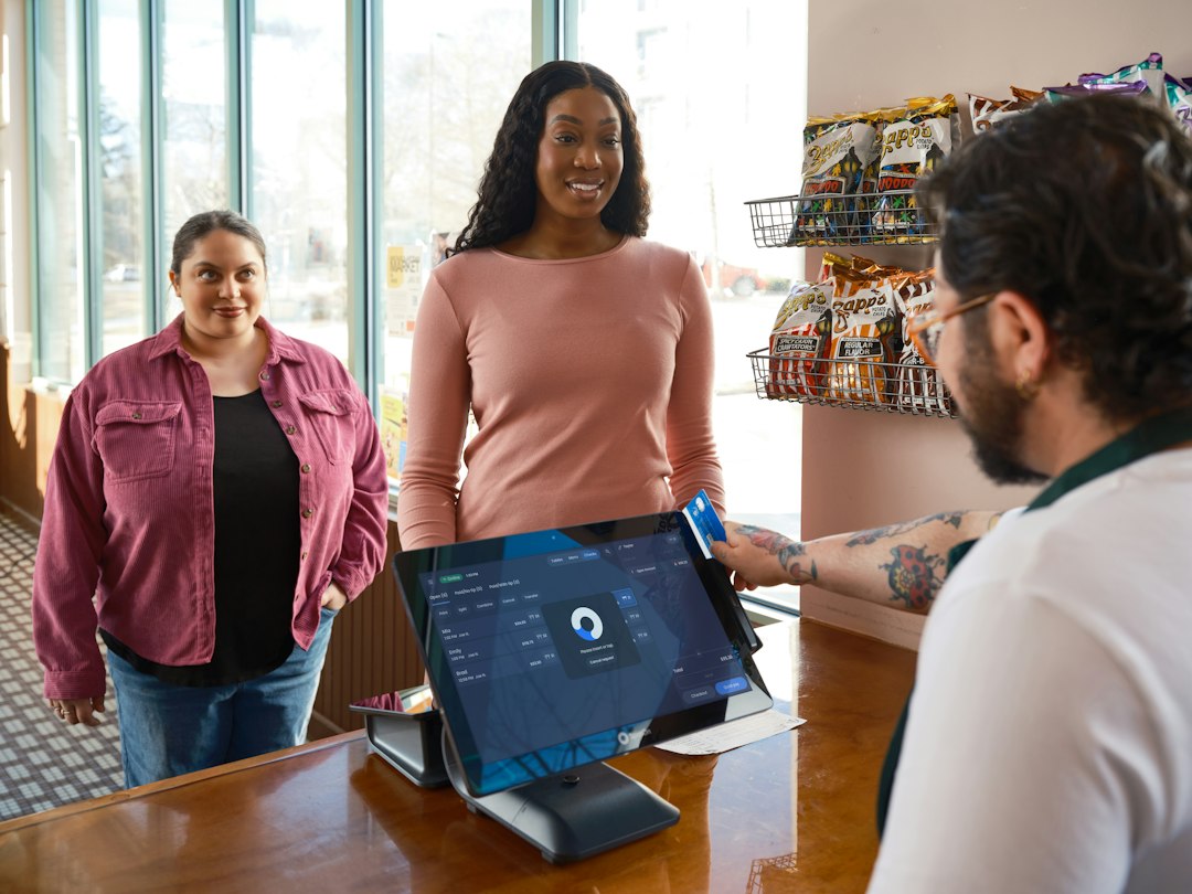Cashier using a POS terminal in a Kenyan retail shop